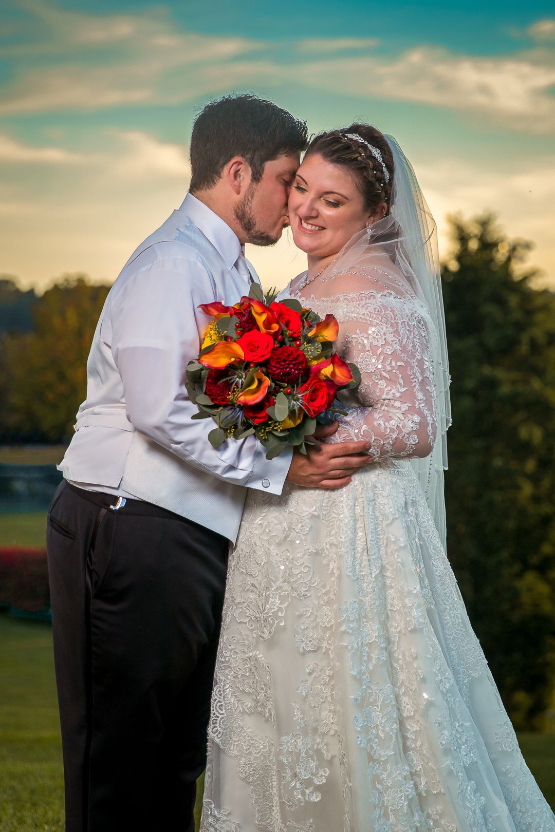 Frederick Maryland Wedding Photographer  -  Romantic sunset wedding portrait with vibrant red and orange bouquet.