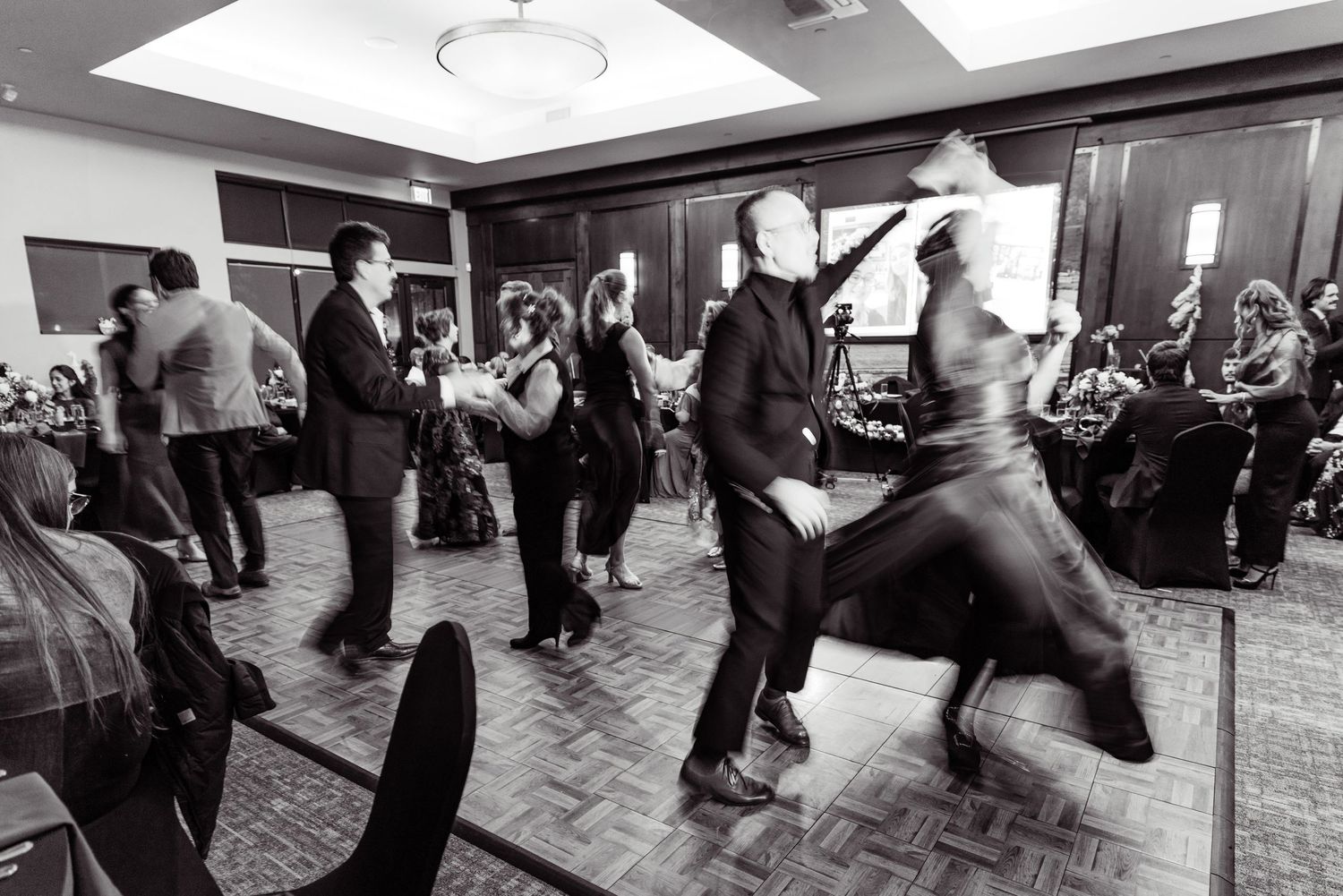 Black and white photographs show couples dancing together at what appears to be a social dance event or party.