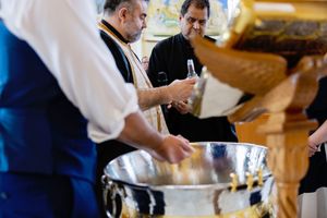 Chefs prepare food at catering stations during an elegant wedding reception.
