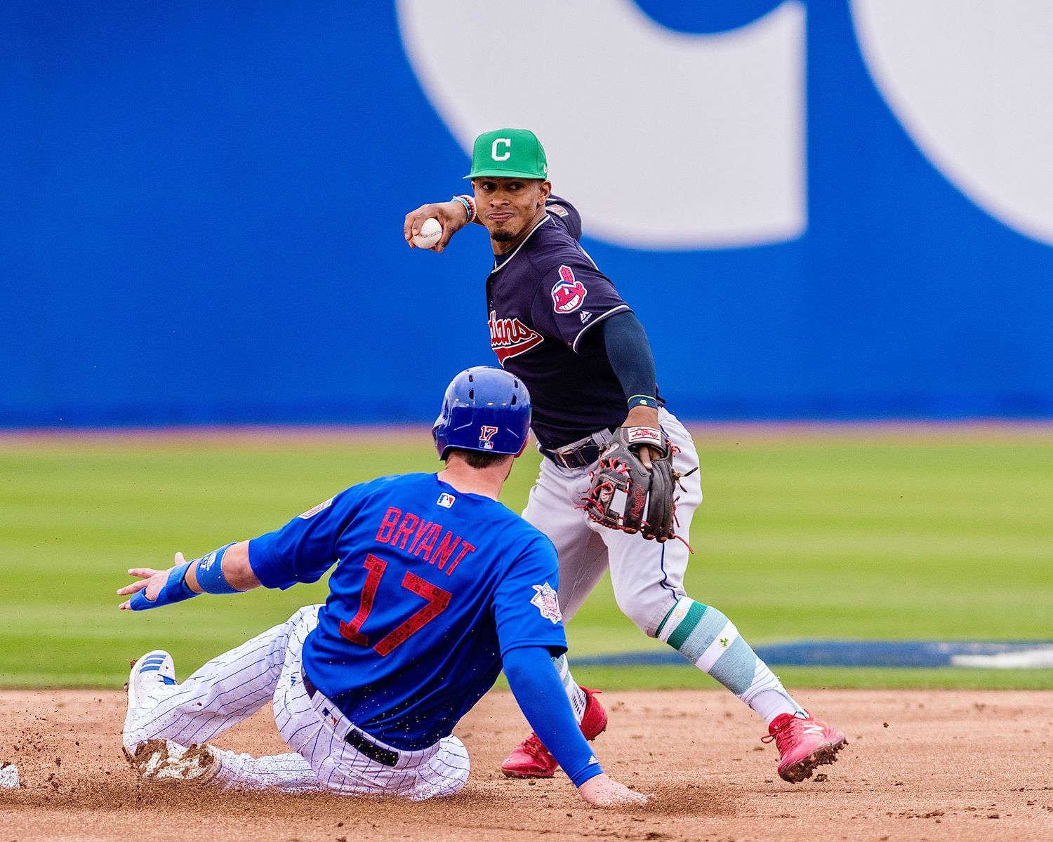 Cleveland Indians shortstop turns a double play as a Cubs runner slides into second base at Cashman Field in Las Vegas.
