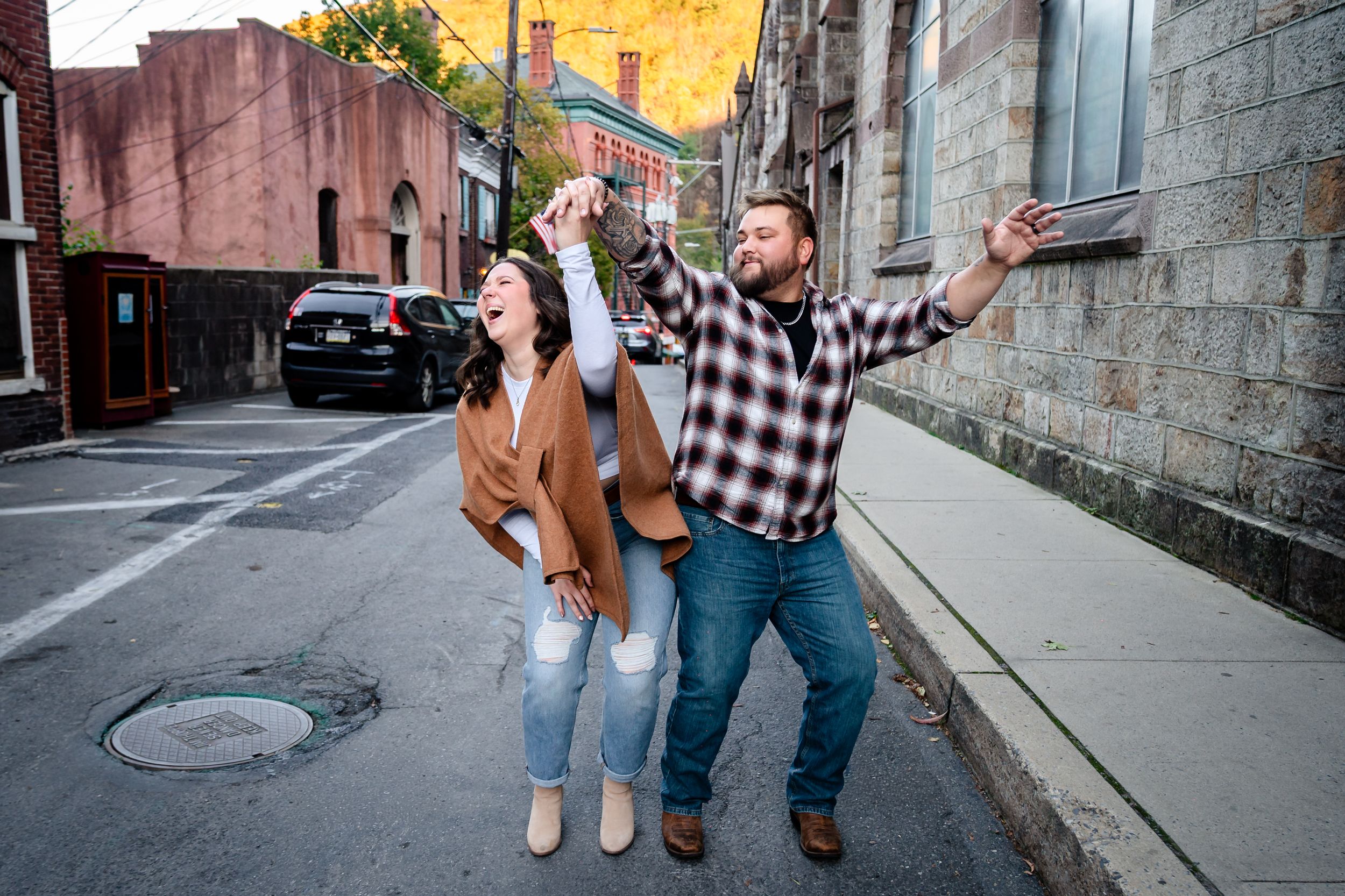 A couple shares playful moments in a series of photos against a stone wall backdrop.