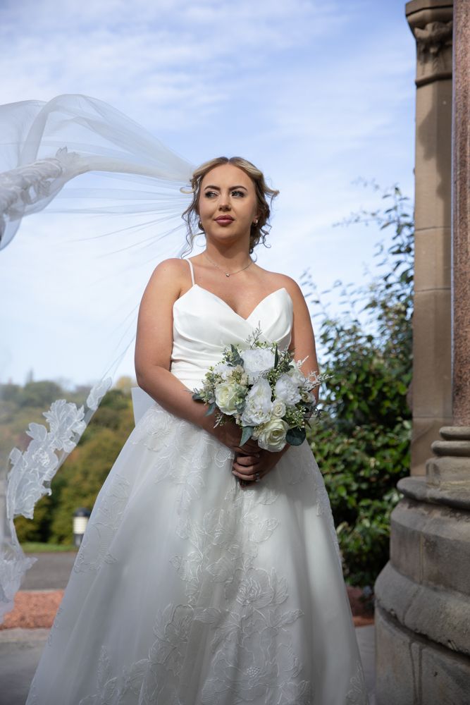 A flowing white wedding dress with delicate lace details is captured in a series of elegant bridal portraits.