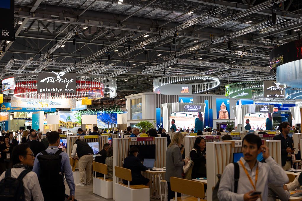 The 2025 WTM conference hall filled with exhibition booths and attendees browsing displays and networking.