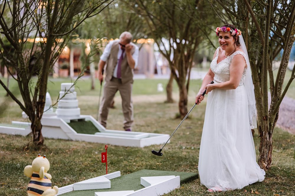 Bride and Groom play golf at their wedding at the  Waterside Country barn and mill lakeside wedding venue, Taunton, somerset