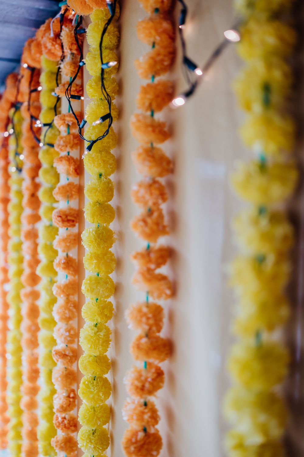 Colorful hanging paper lantern decorations in orange and yellow create a festive ceiling display.