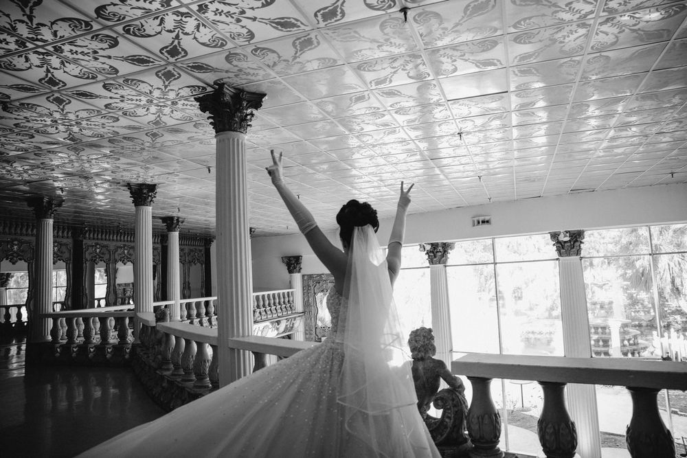 Wedding venue interior with white columns and architectural details in black and white.