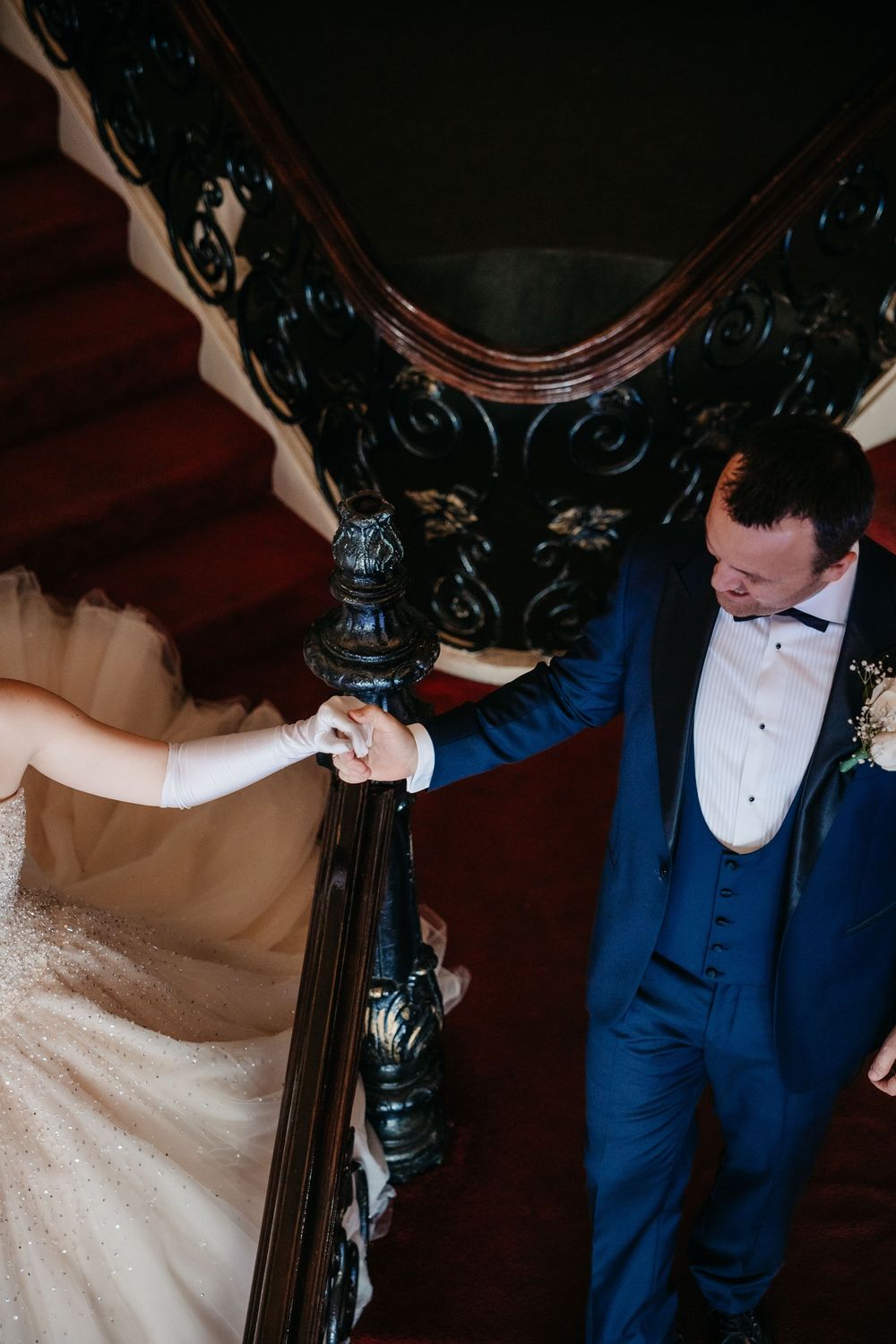 Elegant wedding scene with ornate dark furniture and formal attire.
