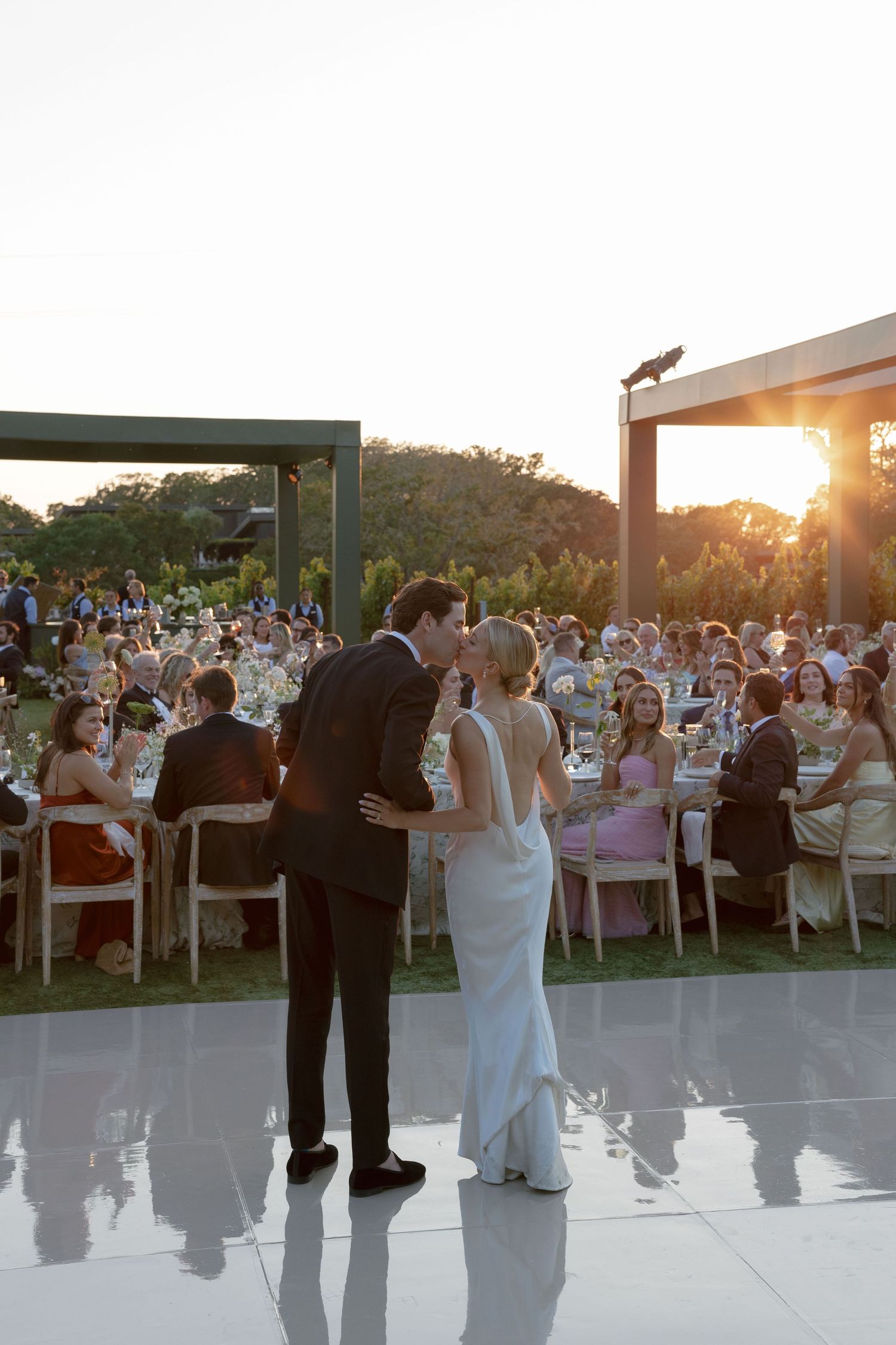 A white wedding dress shows a dramatic ombre effect transitioning from pristine white to smoky grey at the bottom.