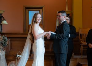 Panoramic sequence of a wedding couple's dance in a rustic venue with wood paneled walls.
