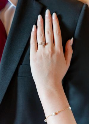 Close-up shots of hands displaying wedding rings and bridal jewelry.