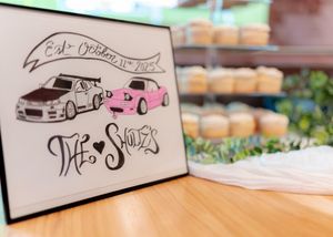Hand-drawn car illustrations on wedding stationery showing vintage and modern vehicles.