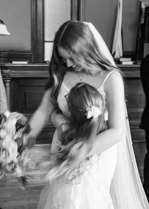 Artistic black and white sequence of a bride adjusting her veil indoors.