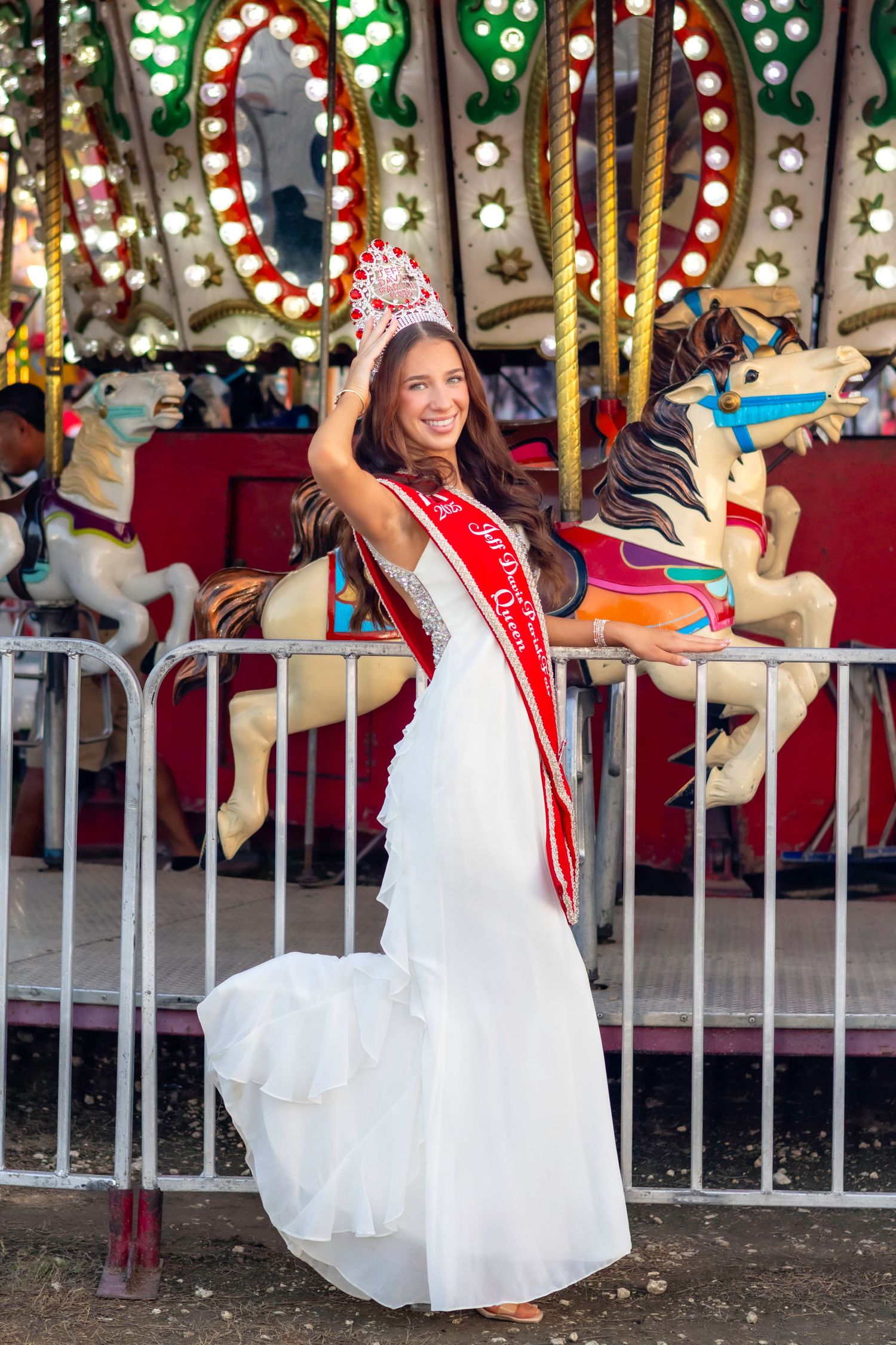 A carousel sequence showing someone in a white dress and red sash enjoying a festive carnival ride.