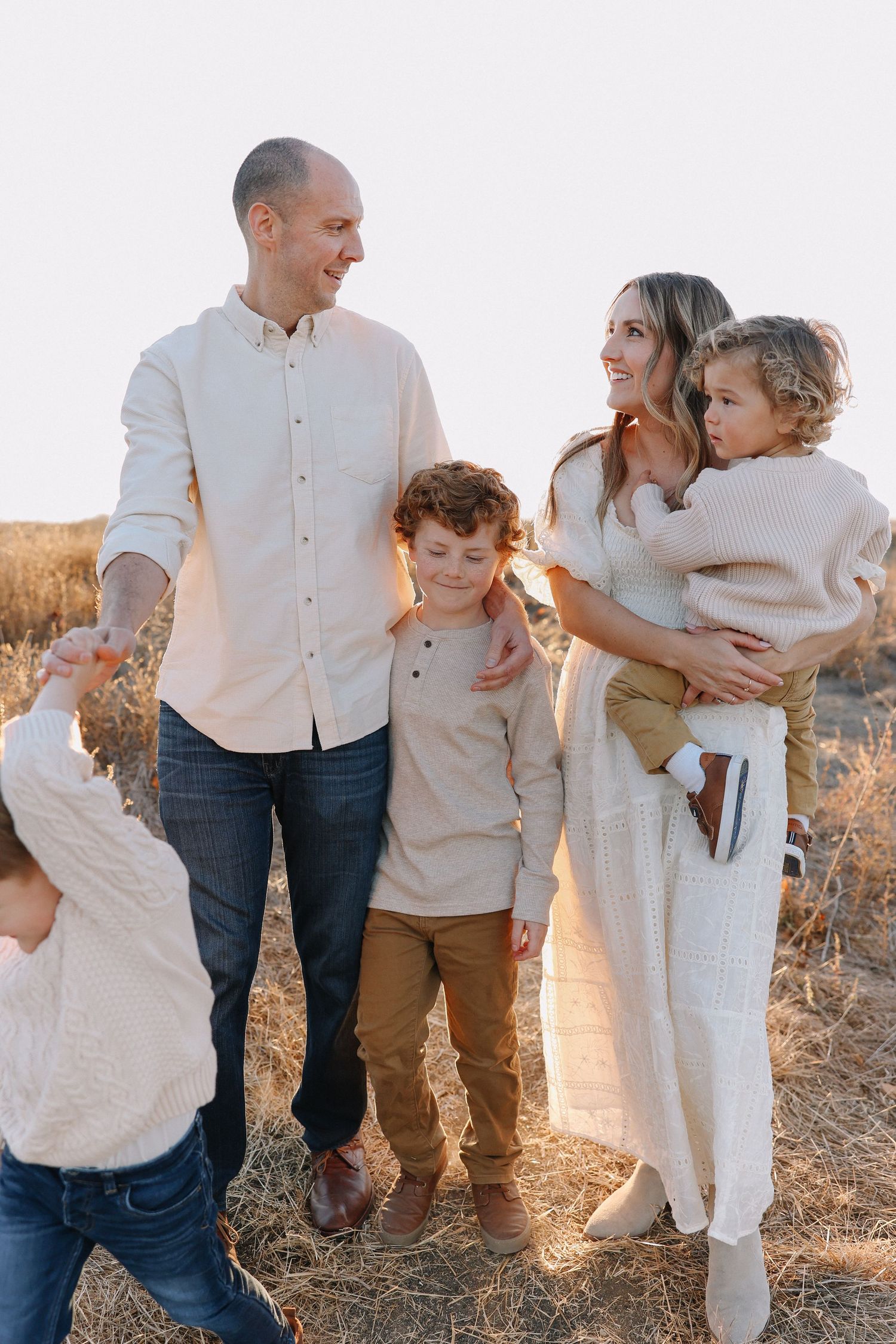 Orange County family photography portrait of mom and dad walking hand in hand with children