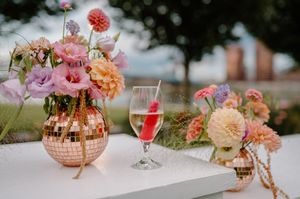 A collage of wedding reception details featuring pink and peach floral arrangements, wine glasses, and table settings from Cincinnati OH