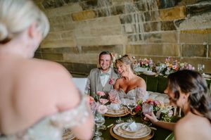 Groomsmen and bridesmaids interacting joyfully during the styled shoot in downtown Cincinnati at Anderson Pavilion.
