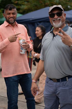 People in casual polo shirts socialize at an outdoor event.