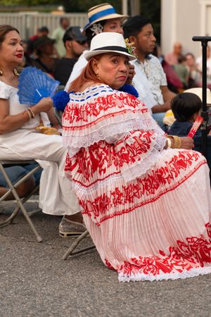 Traditional red and white pleated skirts swirling during a cultural dance performance.