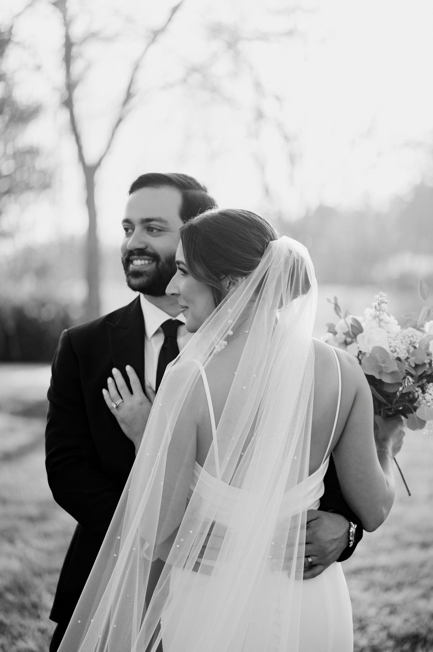 Black and white wedding portraits capturing intimate moments between newlyweds.