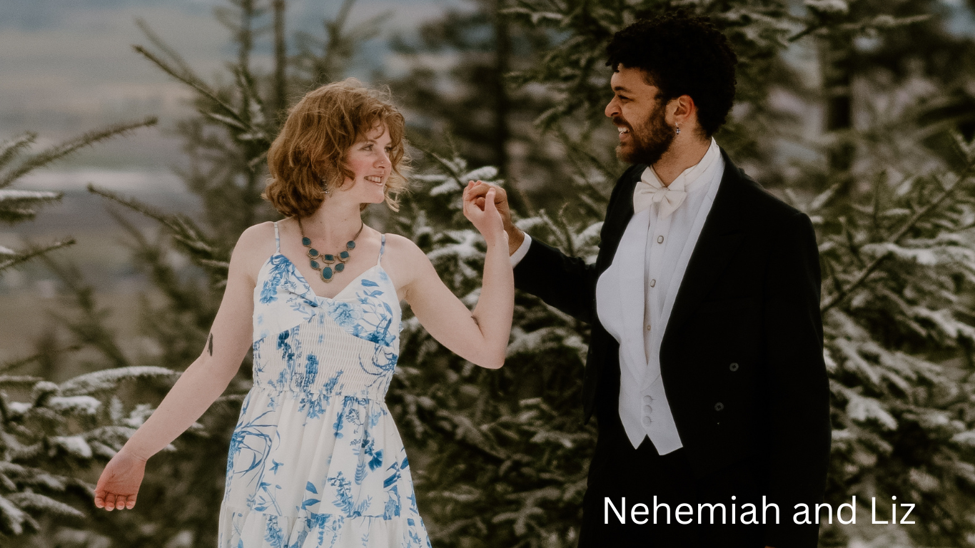 A couple dances together in a snowy forest setting.