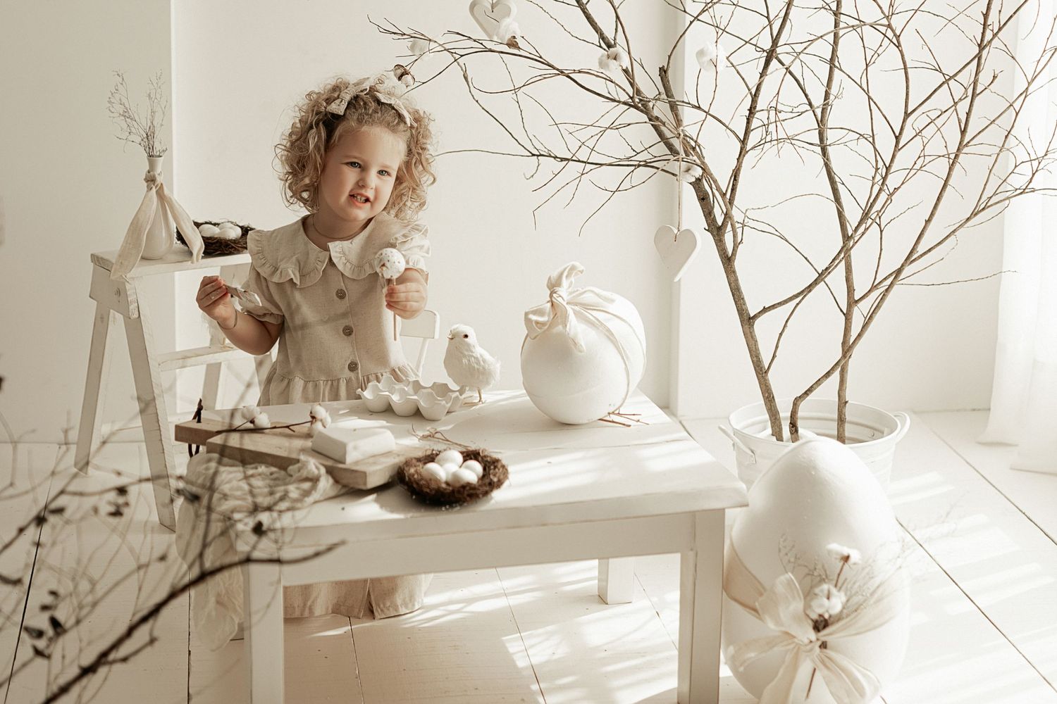 A vintage-style sepia photograph shows a lighthearted tea party scene with ceramic teapots and decorative branches.