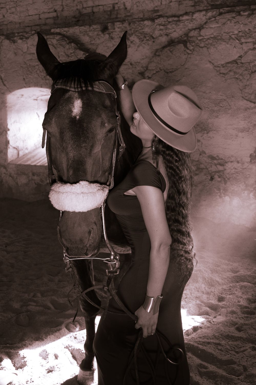 A sepia-toned sequence showing a person in western attire interacting with a dark horse in a rustic setting.