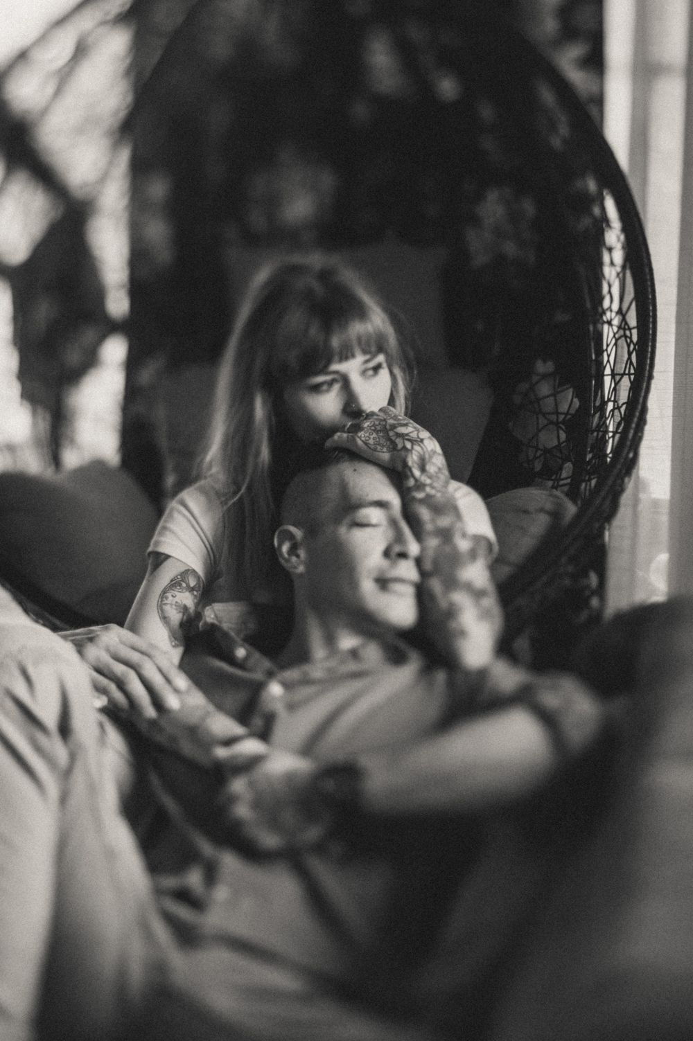 Intimate black and white portrait series showing tender embraces in dramatic lighting.