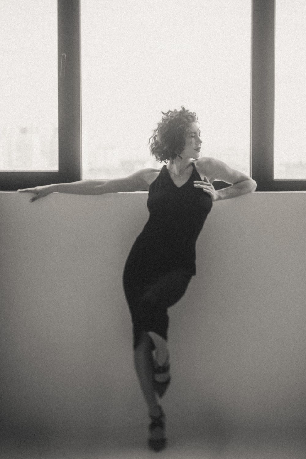 Artistic black and white series showing figure in window light creating dramatic silhouettes.