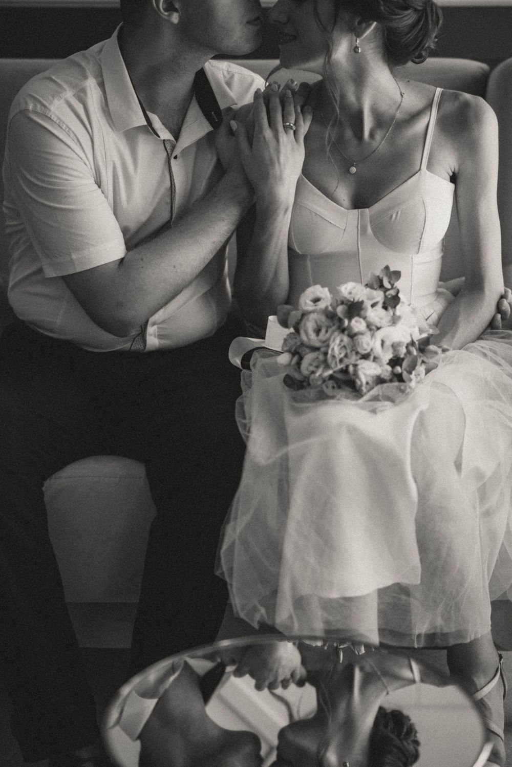 Romantic black and white portrait with couple and floral details.