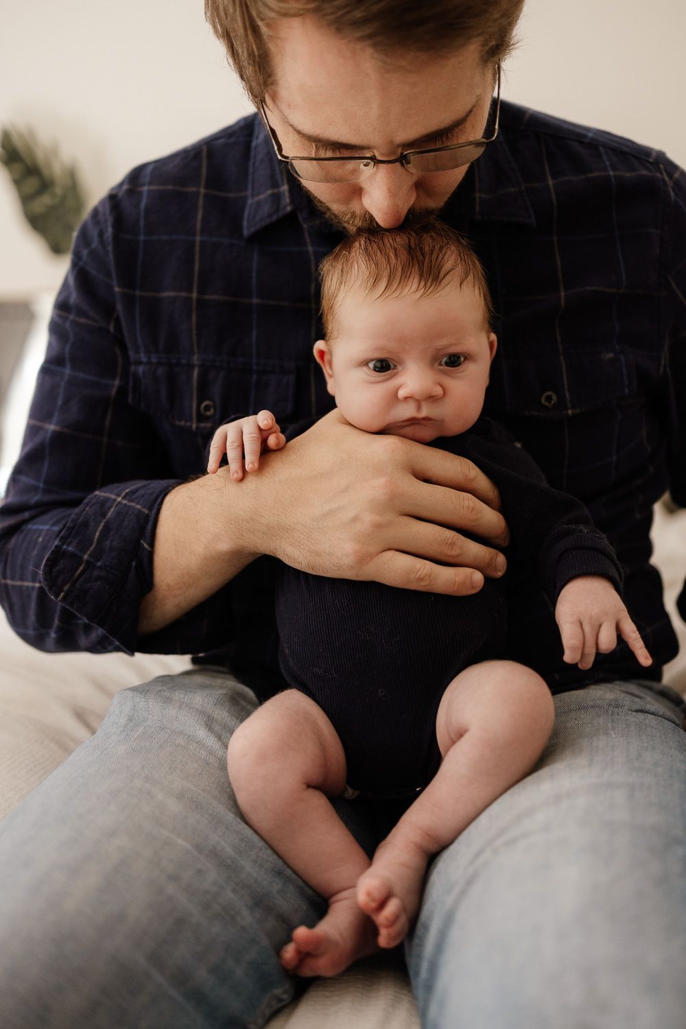 Bay Area Newborn Photographer Cindy Tucey photographs dad kissing baby's head in San Jose