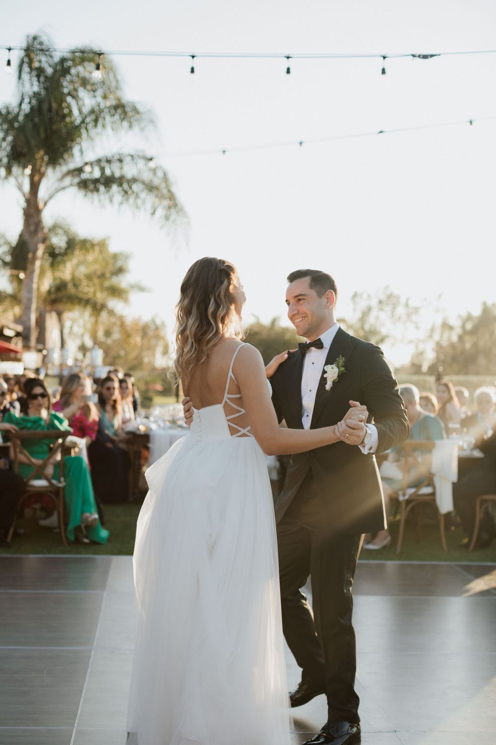 bride and groom first dance during early sunset