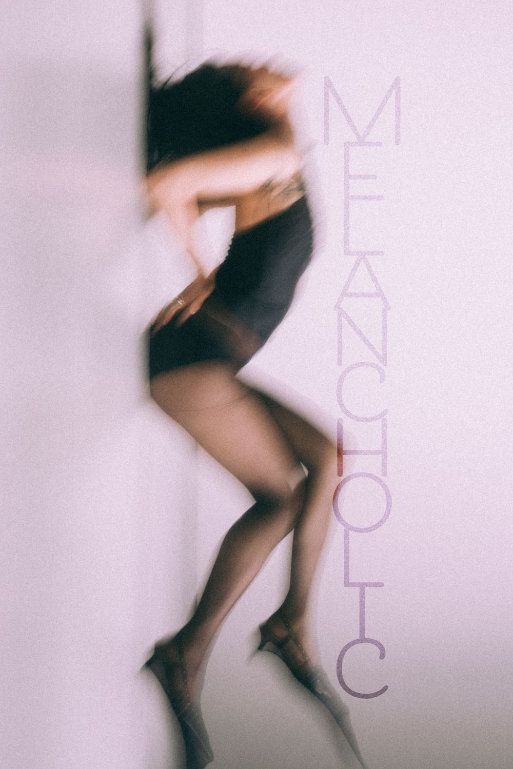 Artistic blurred silhouette of dancer in motion against pink background with 'Melancholic' text.