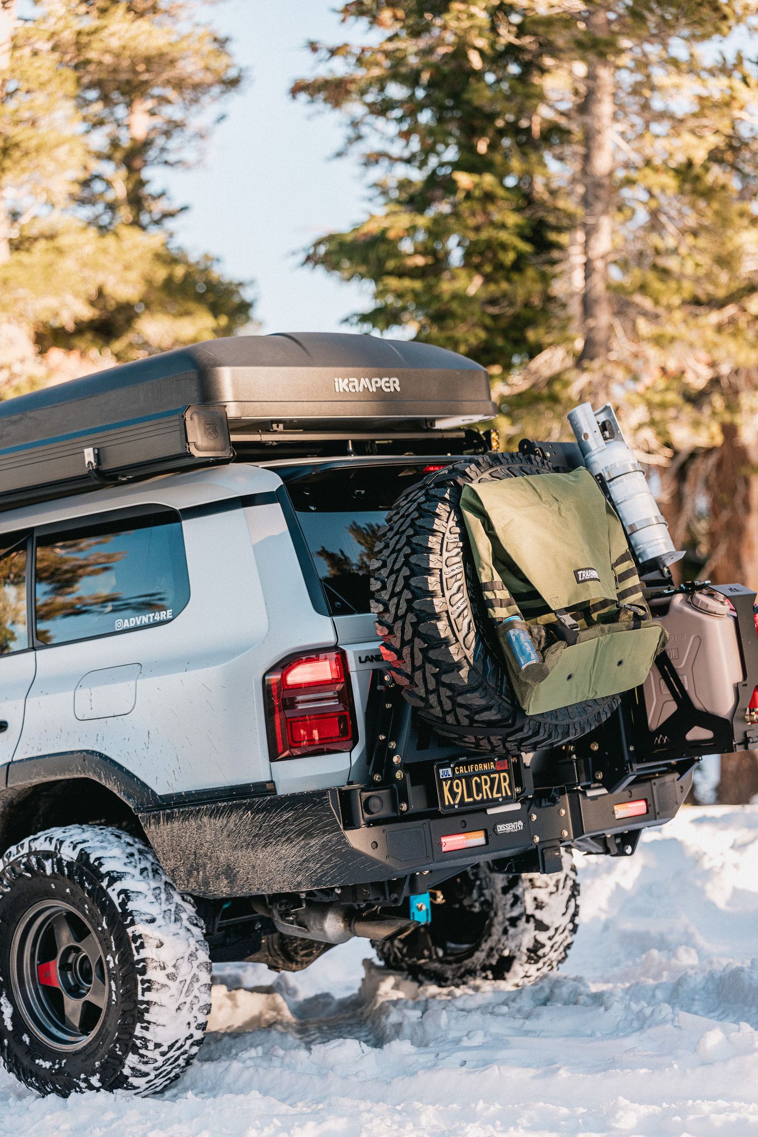 Four sequential shots of an off-road vehicle driving through deep snow with chunky tires and rugged suspension.