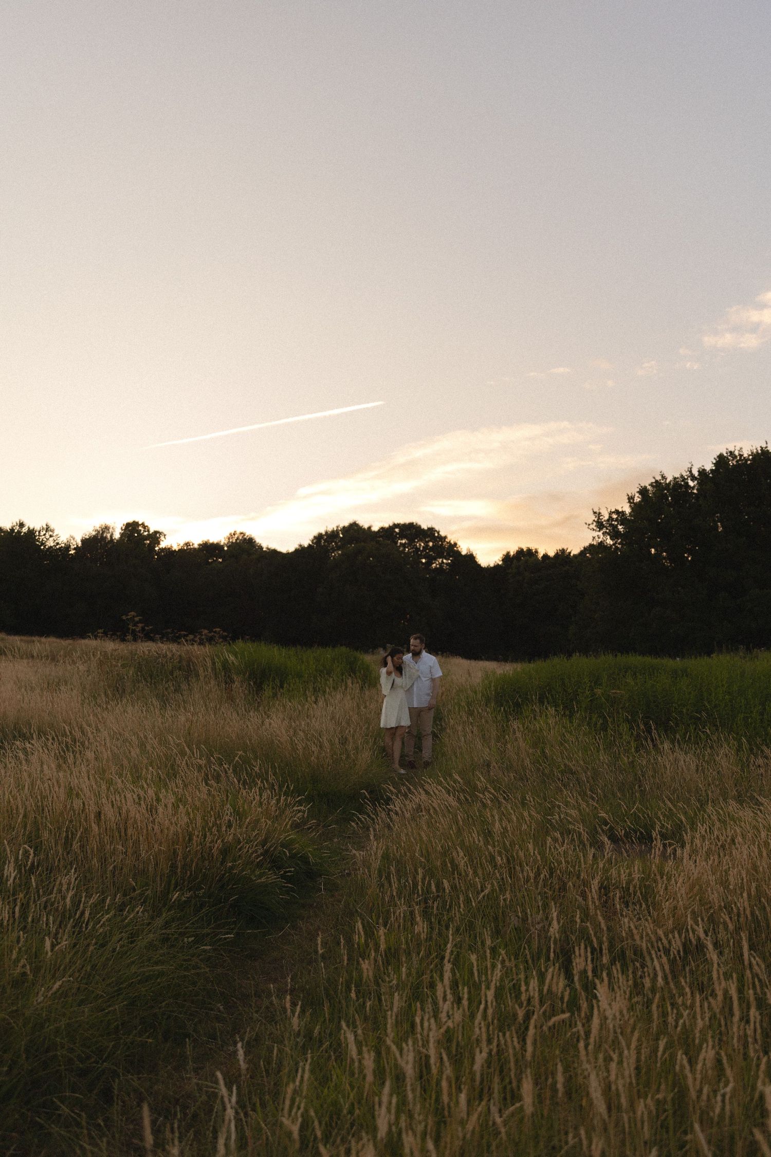 photograph of a couple in a golden field.
