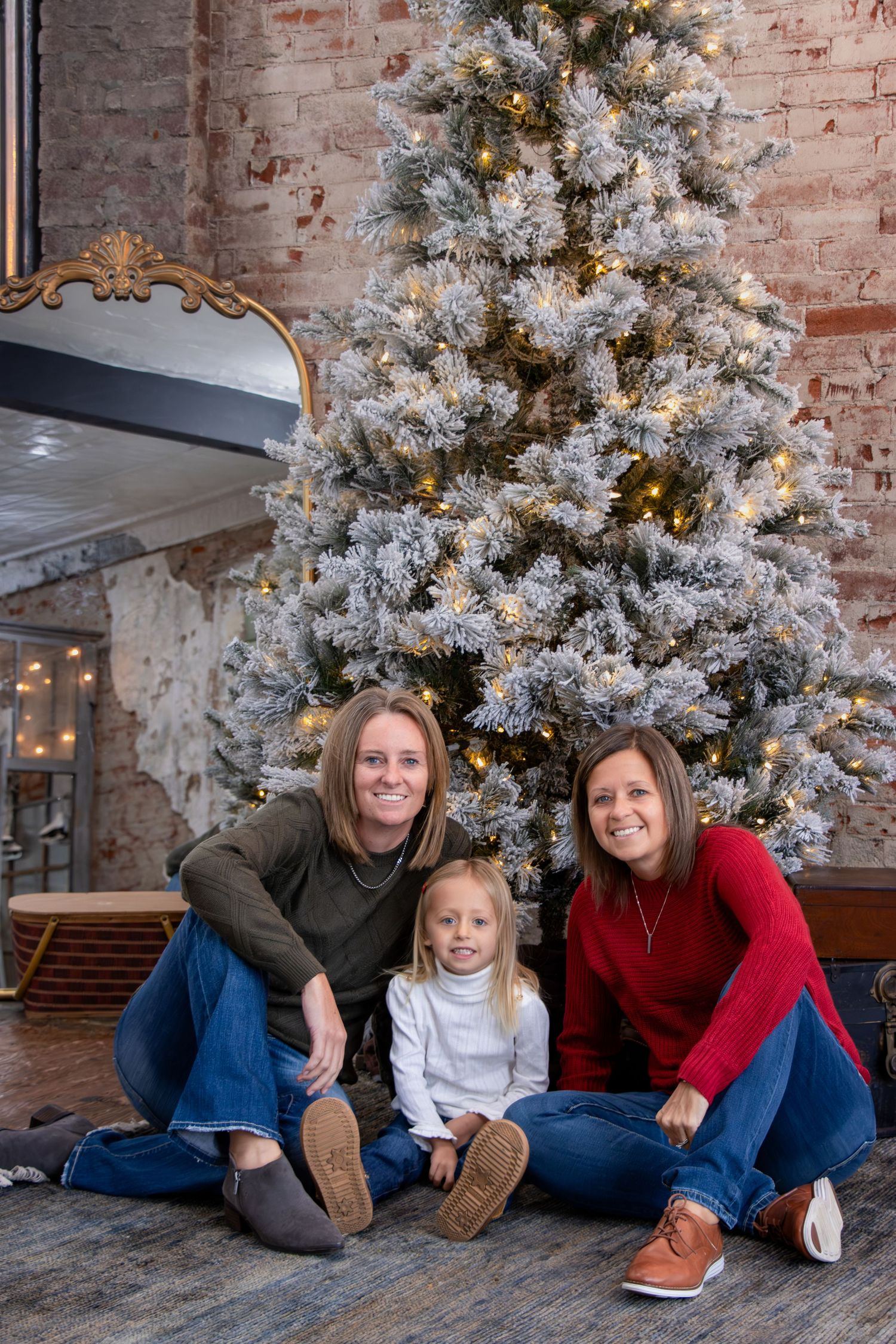 Cincinnati Christmas mini session featuring lesbian couple with daughter holiday portraits, celebrating love, family, and festive seasonal p
