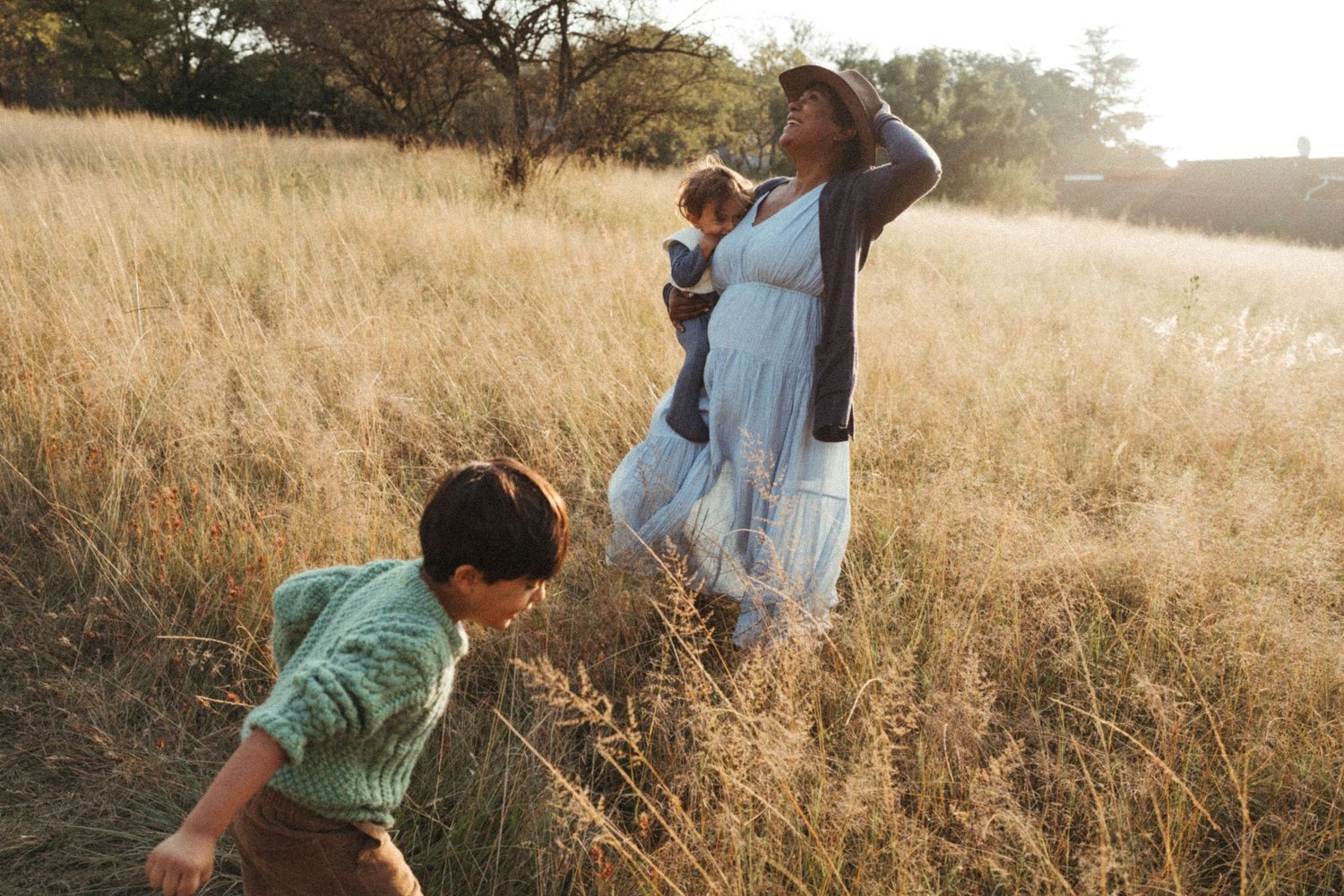 Family enjoying a peaceful moment together in a golden autumn field.