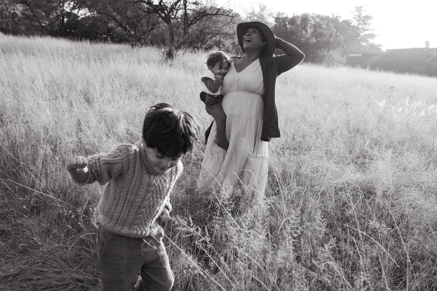 Candid moments of exploration and connection in a sunlit meadow.