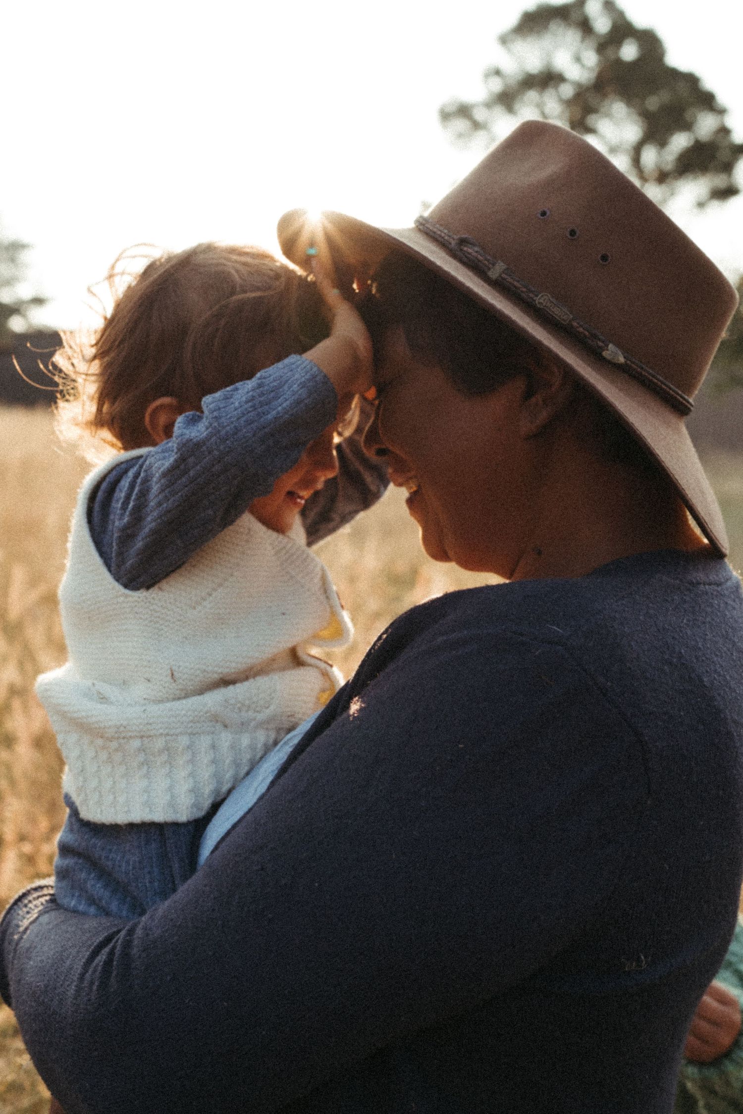 Intimate moment captured between two people during golden hour with sunlight streaming through.