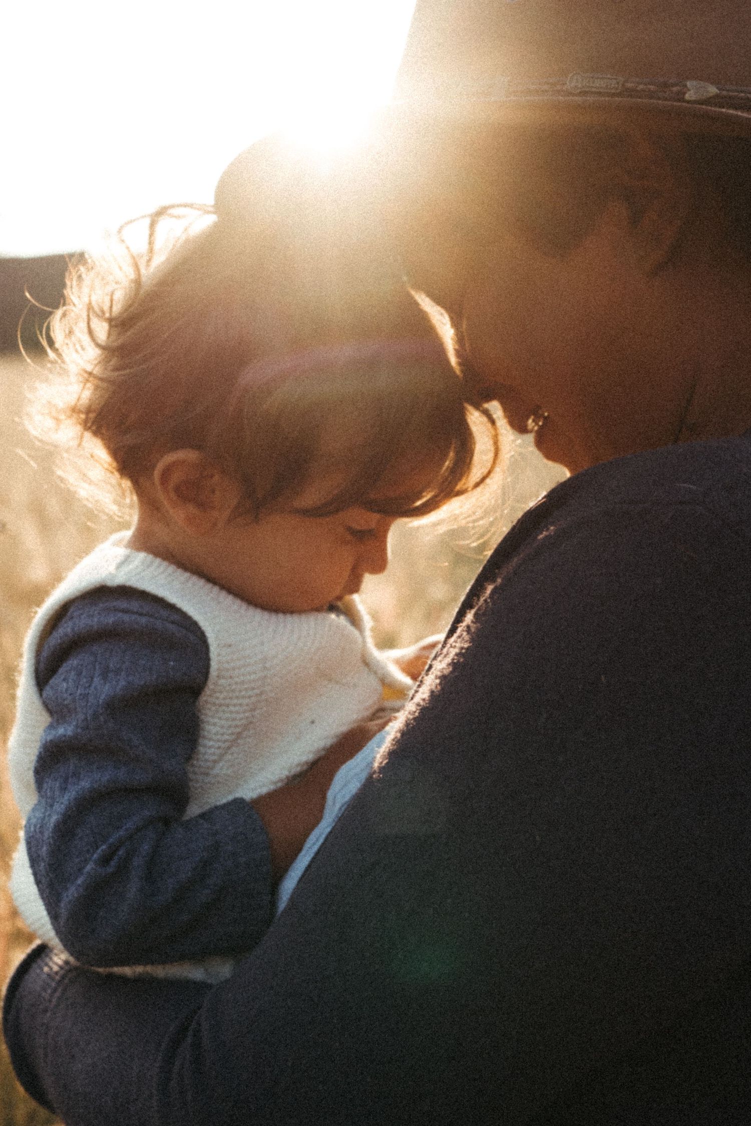 Backlit portrait showing silhouettes in warm golden sunlight during sunset.