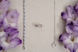A collection of delicate purple and white gladiolus flowers arranged in a repeating pattern along a horizontal line.