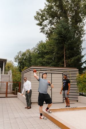 A sequence of images showing a skateboarder attempting a trick on an outdoor patio with wooden ramps.
