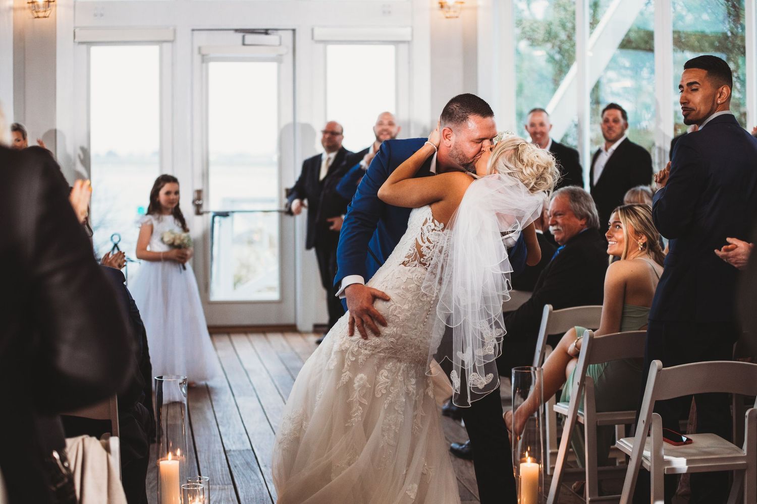 Wedding ceremony in bright indoor venue with couple exchanging vows at Chesapeake Bay Beach Club. Annapolis videographer