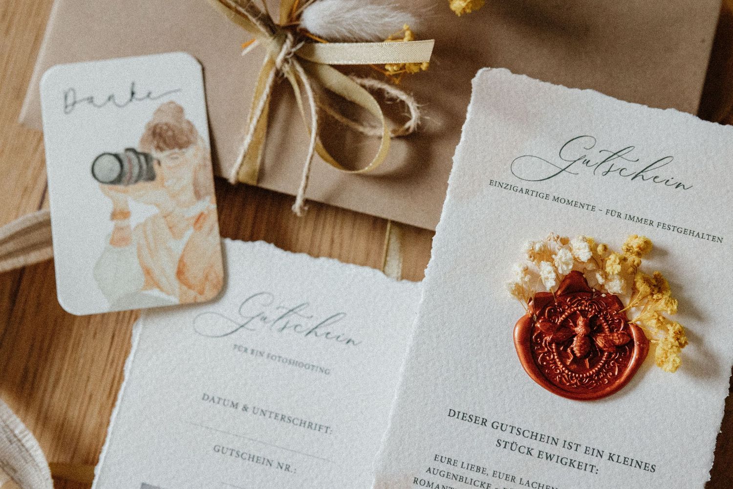 Elegant wedding invitation suite with calligraphy text and wax seal displayed on wooden surface with floral elements.