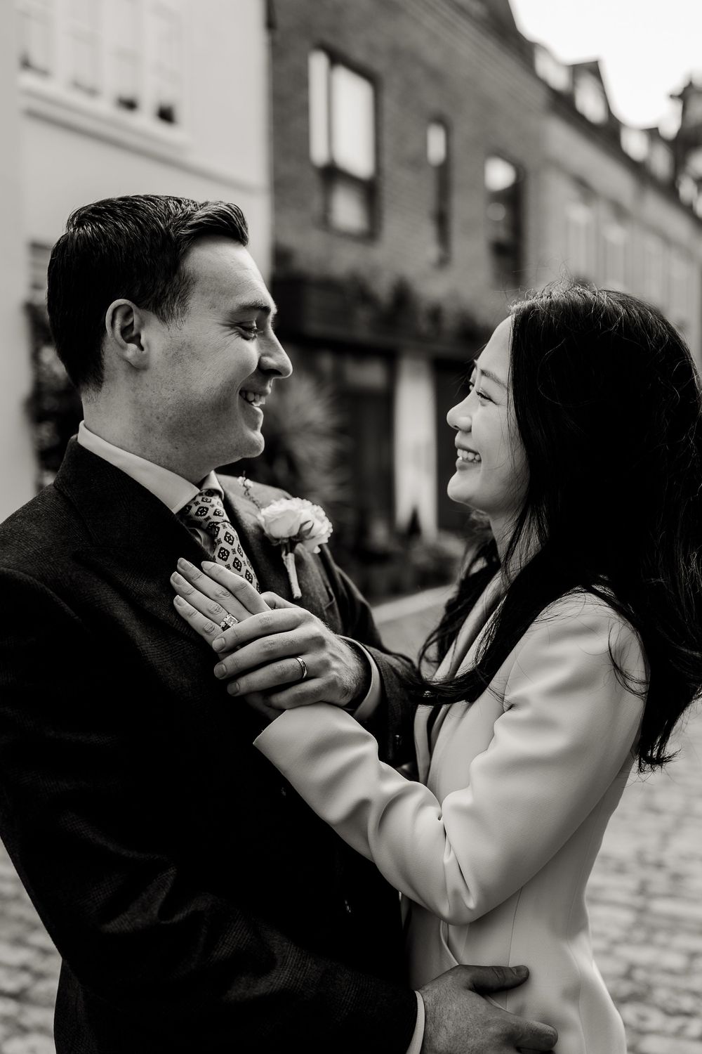 A black and white photo sequence shows two people in an intimate emotional confrontation on a city street.