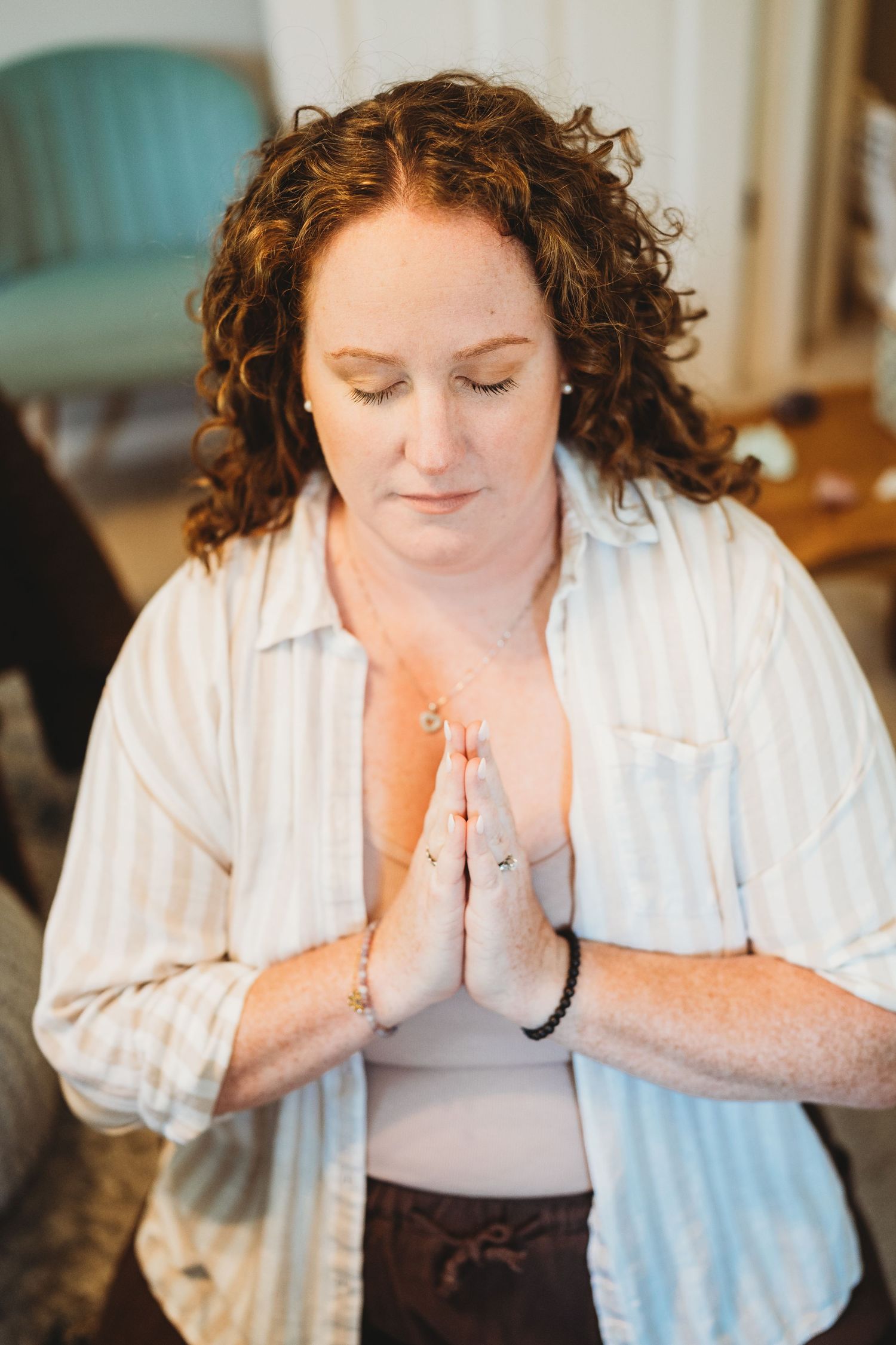 A series of photos showing someone in a white shirt praying or meditating with hands clasped together.