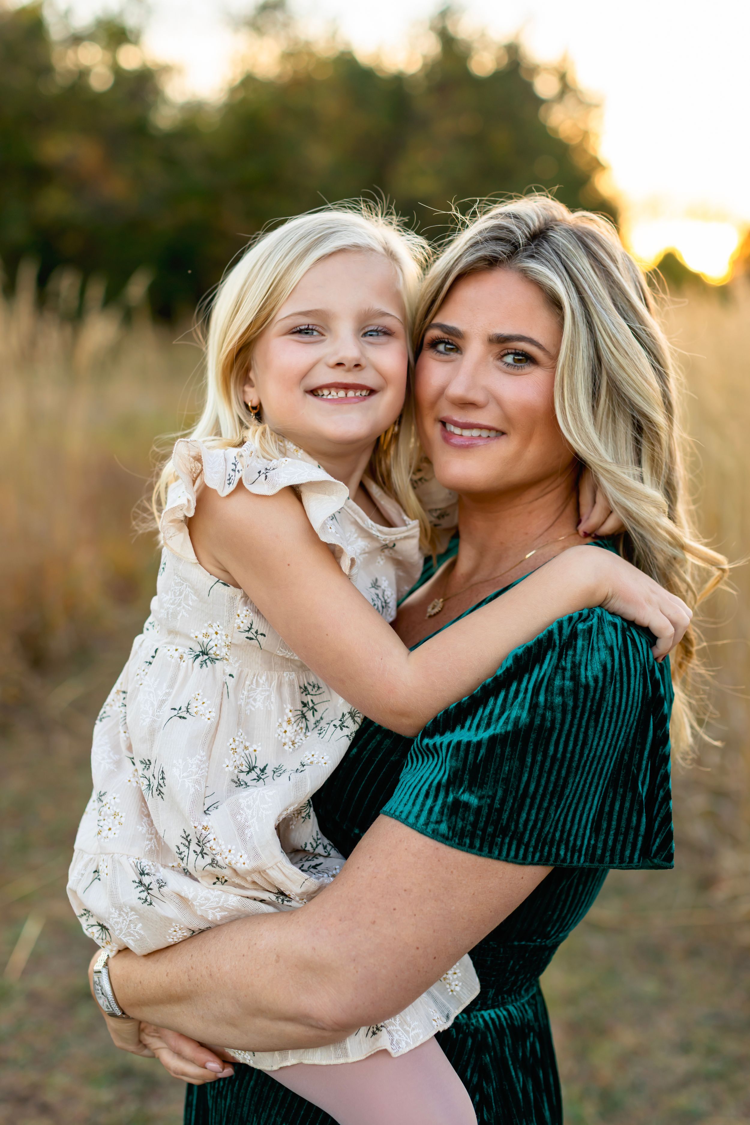 A series of warm sunset portraits showing embraces and laughter in a field with golden light.