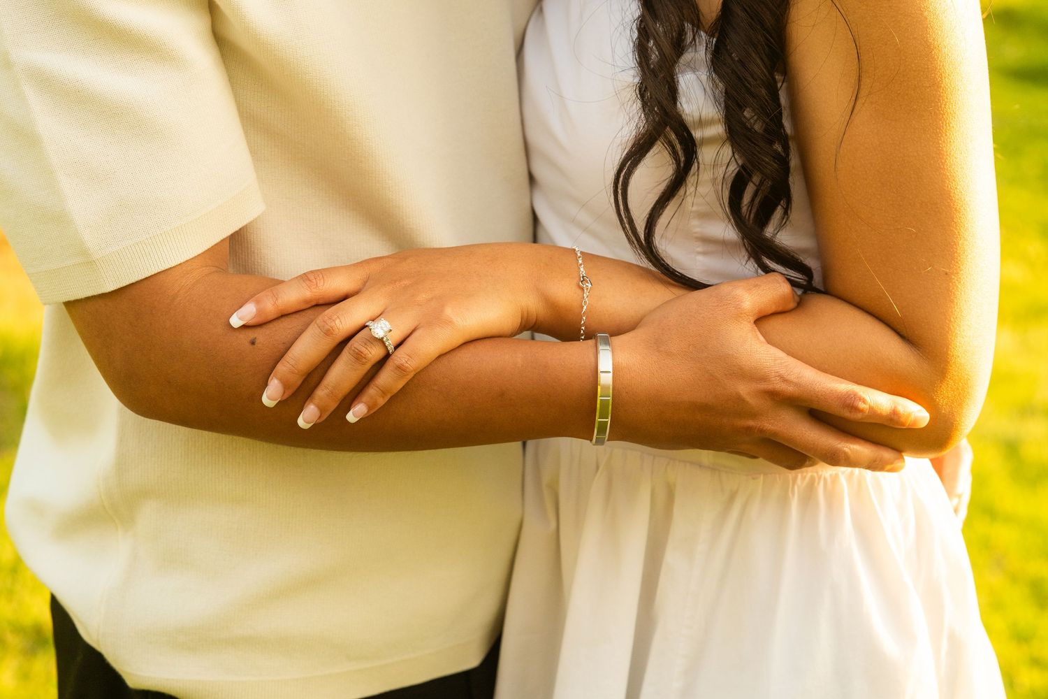 Outdoor proposal scene with white floral arrangements in a natural setting.