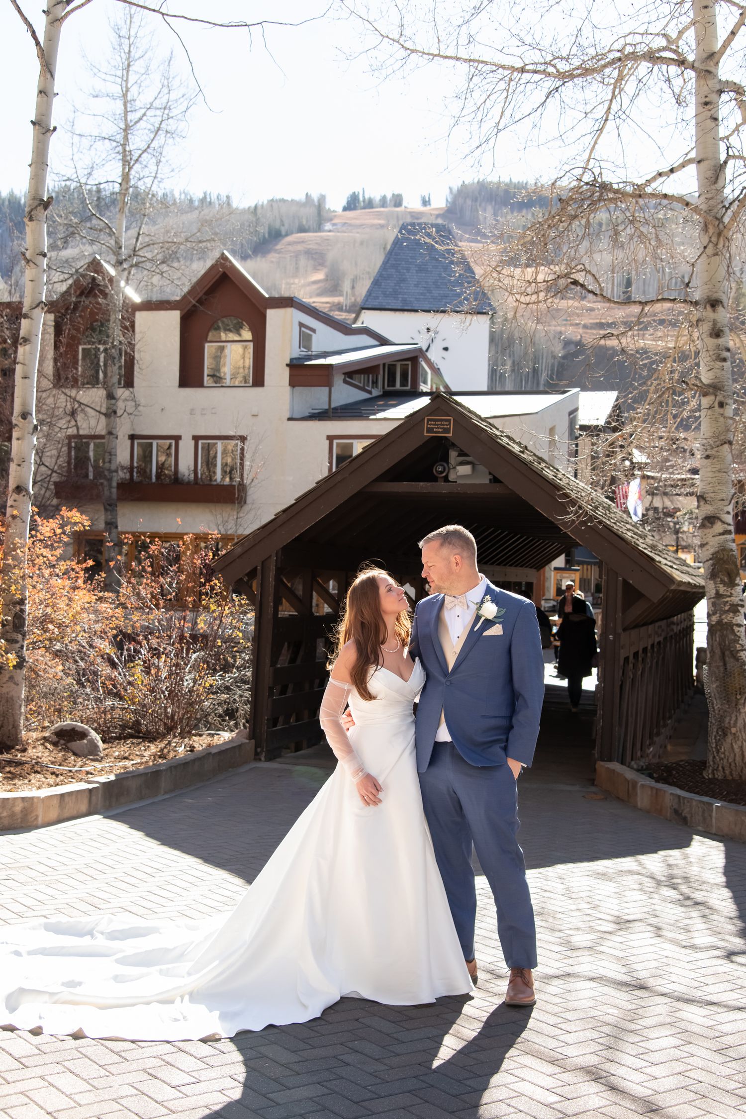 Wedding photos of bride and groom at the covered bridge in Vail Village Colorado