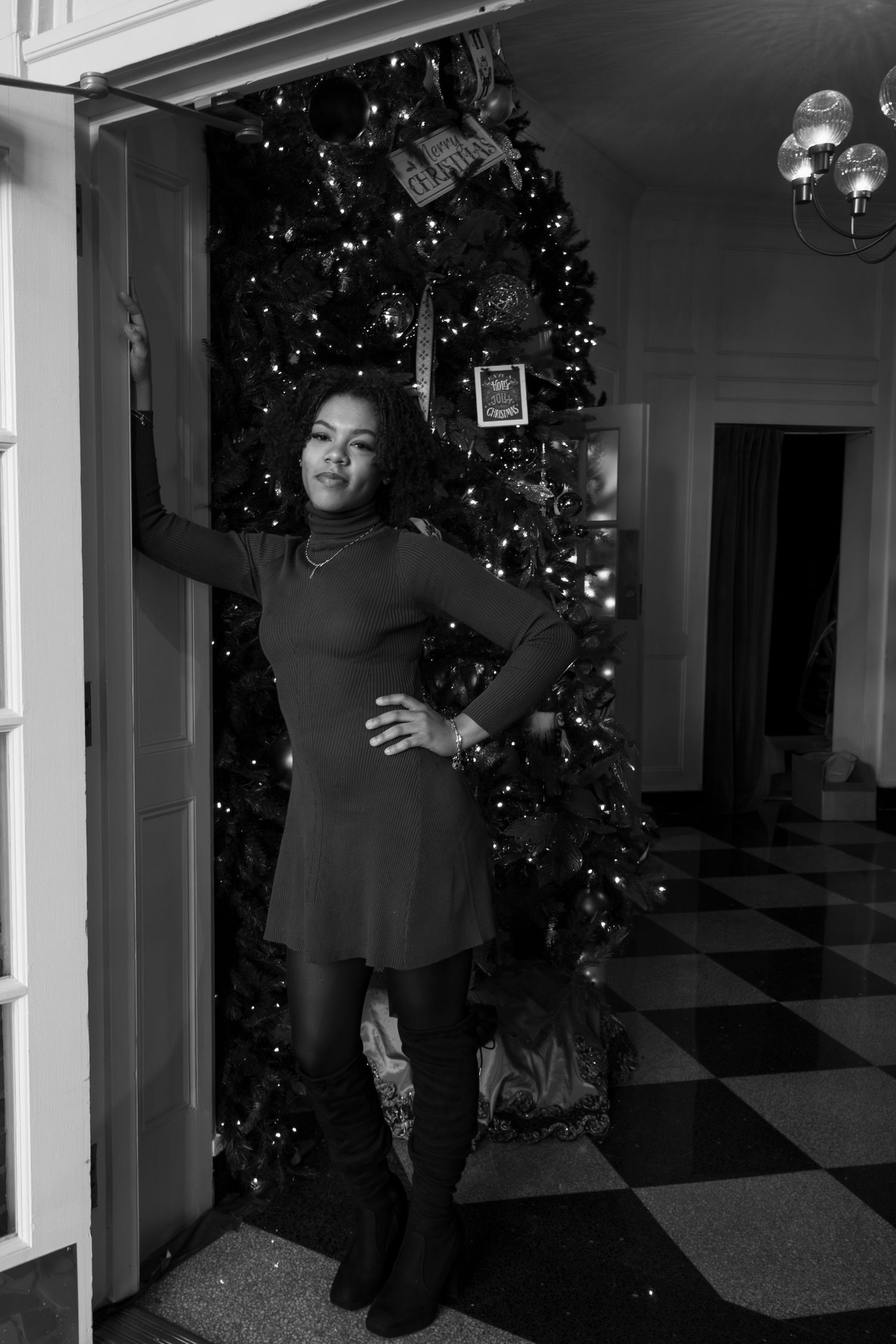 Security camera footage shows a dark silhouette moving through a hallway decorated with Christmas trees and lights.