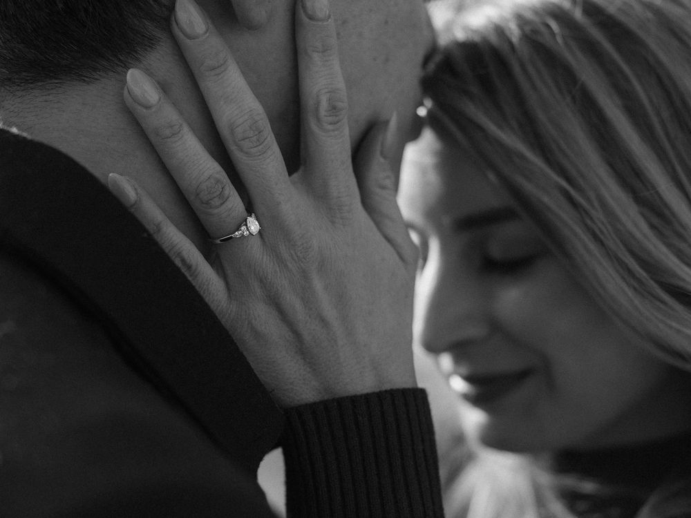 A romantic black and white close-up photo showing a tender intimate moment between a couple.
